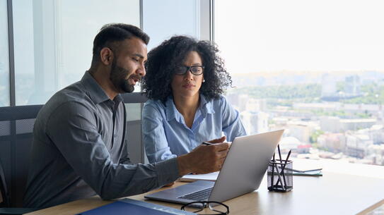 A man and a woman working together in an office