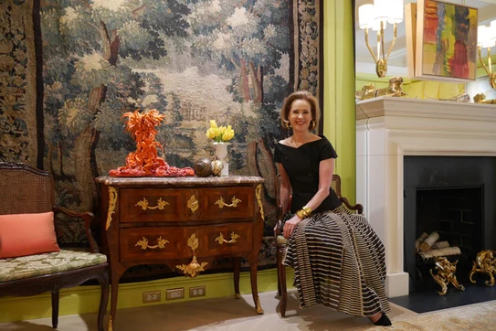 Maureen footer seated in front of a large wall hanging 