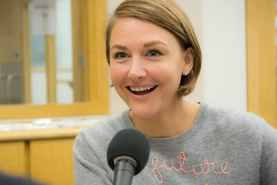 Brooke Jones-Chinetti sitting at a microphone