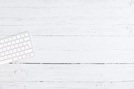 A white keyboard sitting on a white tabletop. Photo by iMattSmart on Unsplash