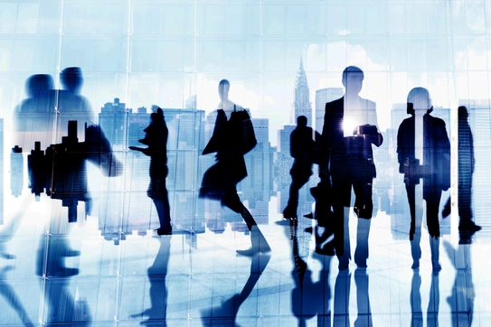 People walking and interacting in a business district of a city