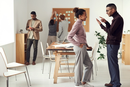two people in an office talking 