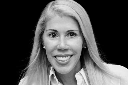 black and white head shot photo with Jen Prosek smiling at the camera