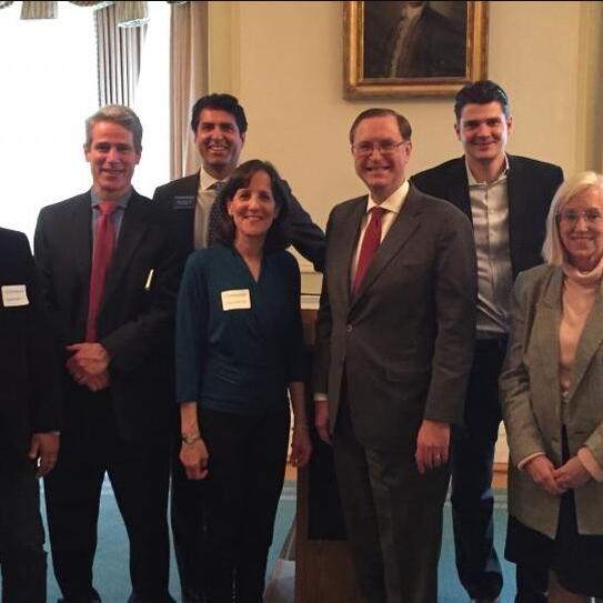 Dean Glenn Hubbard (front row, second from left) attended a graduation ceremony marking the first year of the Alumni Club of Boston's mentorship program. This year, the program has 11 mentor-mentee pairs from a wide range of graduating years.